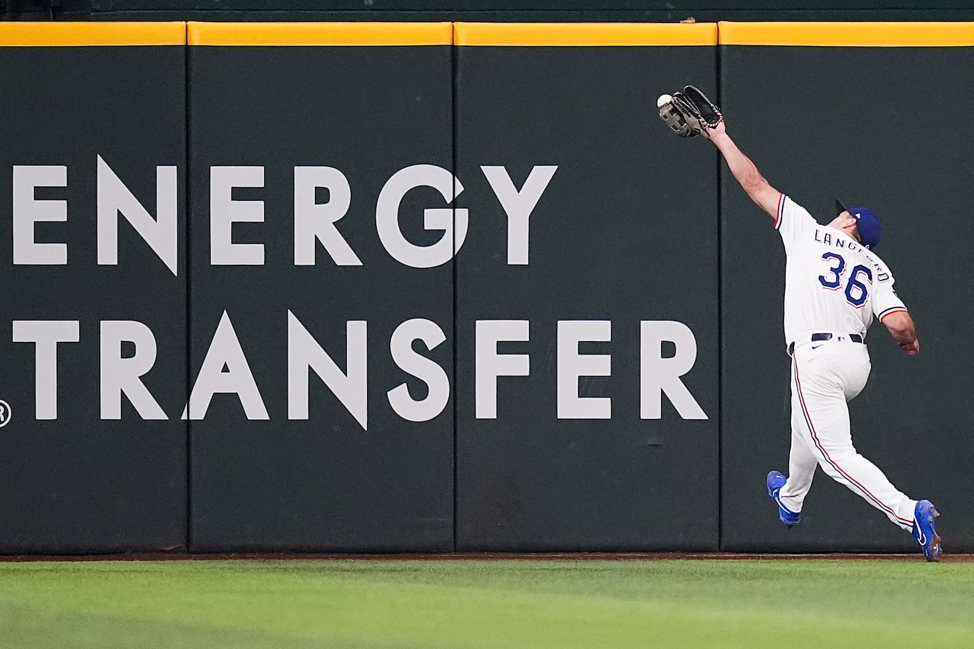 Texas Rangers center fielder Wyatt Langford makes a running catch on a line drive off the...