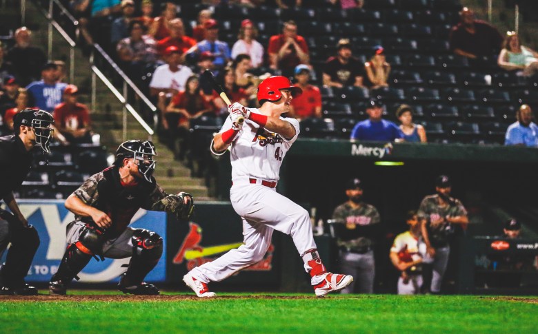 A baseball player swings his bat during a game