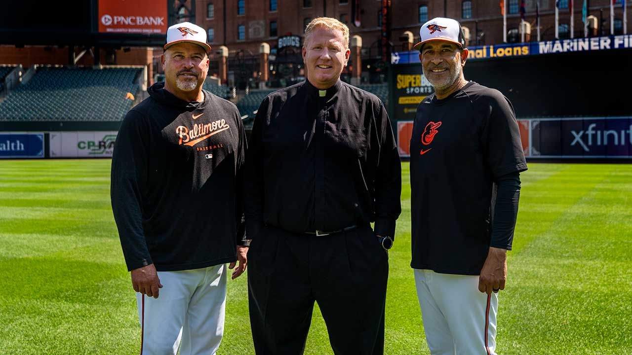 Father Dennis Baker on field at Camden Yards