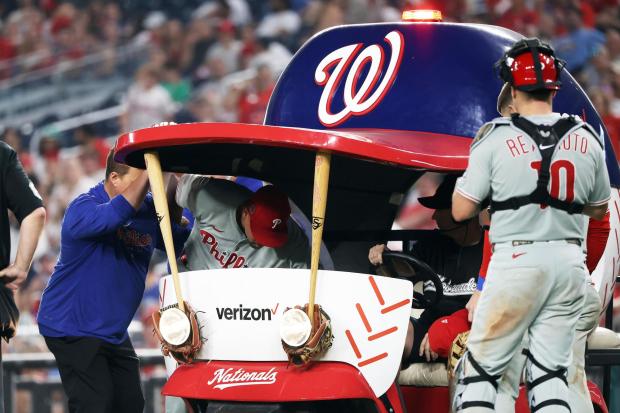 Philadelphia Phillies pitcher Jhoan Duran gets carted off of the field during the ninth inning of a baseball game against the Washington Nationals, Friday, Aug. 15, 2025, in Washington. (AP Photo/Daniel Kucin Jr.)