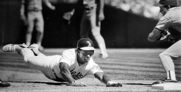 Oakland, CA June 12, 1990: Oakland Athletics' Rickey Henderson slides into third base at the Oakland Coliseum after being caught in a rundown during a game against the Texas Rangers. (Tom Duncan / Staff Archives)