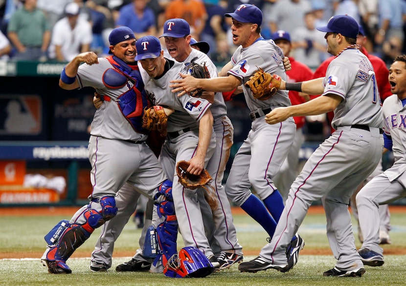 Texas Rangers Bengie Molina (11), Cliff Lee (33), Michael Young (10) David Murphy crowd Lee...