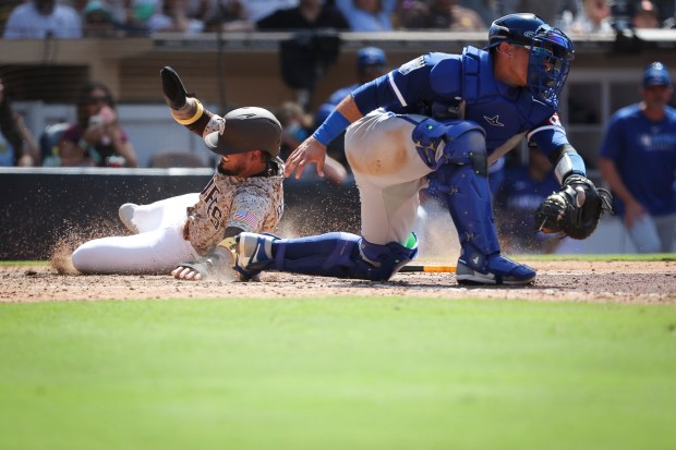 The Padres' Luis Arraez scores the winning run against the Royals' Freddy Fermin during the ninth inning at Petco Park on Sunday, June 22, 2025 in San Diego, CA. (Meg McLaughlin / The San Diego Union-Tribune)