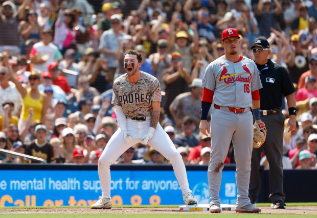 Jackson Merrill #3 of the San Diego Padres celebrates a three run triple in the eighth inning as Nolan Gorman #16 of the St. Louis Cardinals looks on at Petco Park on Aug. 3, 2025 in San Diego, California. (K.C. Alfred / The San Diego Union-Tribune)