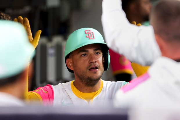 Jose Iglesias #7 of the San Diego Padres is greeted in the dugout after scoring a run against the St. Louis Cardinals during the fifth inning at Petco Park on Friday, Aug. 1, 2025 in San Diego, CA. (Meg McLaughlin / The San Diego Union-Tribune)