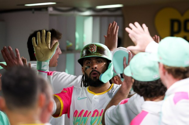 Fernando Tatis Jr. #23 of the San Diego Padres is greeted in the dugout after scoring a run against the St. Louis Cardinals during the fifth inning at Petco Park on Friday, Aug. 1, 2025 in San Diego, CA. (Meg McLaughlin / The San Diego Union-Tribune)