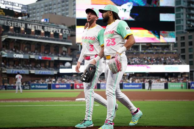 Jackson Merrill #3 and Fernando Tatis Jr. #23 of the San Diego Padres walk together back to the dugout during the fifth inning against the St. Louis Cardinals at Petco Park on Friday, Aug. 1, 2025 in San Diego, CA. (Meg McLaughlin / The San Diego Union-Tribune)
