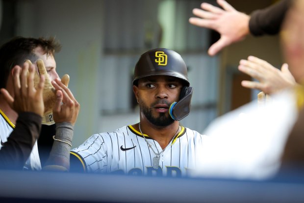 Xander Bogaerts #2 of the San Diego Padres is congratulated in the dugout after scoring a run against the St. Louis Cardinals during the second inning at Petco Park on Saturday, Aug. 2, 2025 in San Diego, CA. (Meg McLaughlin / The San Diego Union-Tribune)