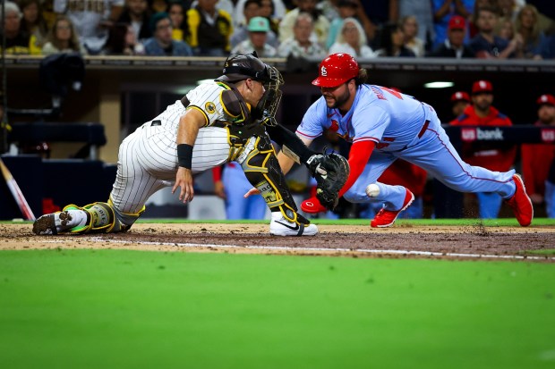 Alec Burleson #41 of the St. Louis Cardinals slides into home against Freddy Fermin #54 of the San Diego Padres during the fifth inning at Petco Park on Saturday, Aug. 2, 2025 in San Diego, CA. (Meg McLaughlin / The San Diego Union-Tribune)