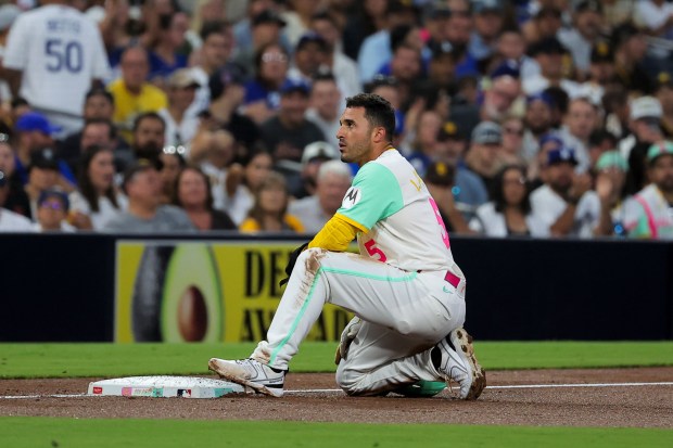 Ramon Laureano #5 of the San Diego Padres kneels near third base after being caught stealing against the Los Angeles Dodgers during the third inning at Petco Park on Friday, Aug. 22, 2025 in San Diego, CA. (Meg McLaughlin / The San Diego Union-Tribune)