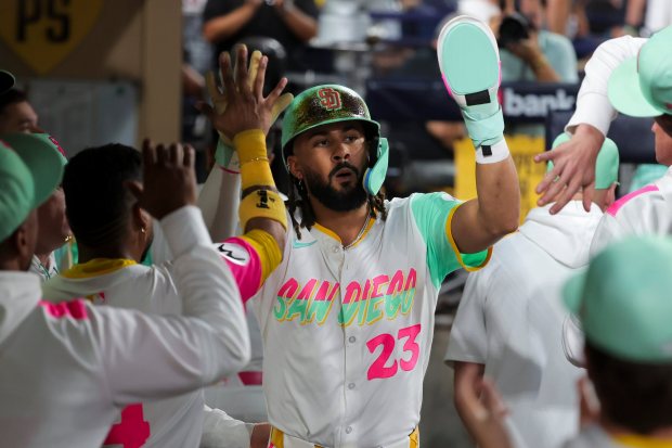 Fernando Tatis Jr. #23 of the San Diego Padres is congratulated in the dugout after scoring as run against the Los Angeles Dodgers during the fourth inning at Petco Park on Friday, Aug. 22, 2025 in San Diego, CA. (Meg McLaughlin / The San Diego Union-Tribune)