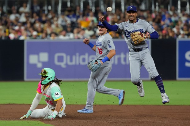 Mookie Betts #50 of the Los Angeles Dodgers tags out Fernando Tatis Jr. #23 of the San Diego Padres before turning the double play during the sixth inning at Petco Park on Friday, Aug. 22, 2025 in San Diego, CA. (Meg McLaughlin / The San Diego Union-Tribune)