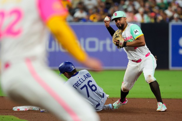 Xander Bogaerts #2 of the San Diego Padres tags out Alex Freeland #76 of the Los Angeles Dodgers and turns the double play during the eighth inning at Petco Park on Friday, Aug. 22, 2025 in San Diego, CA. (Meg McLaughlin / The San Diego Union-Tribune)