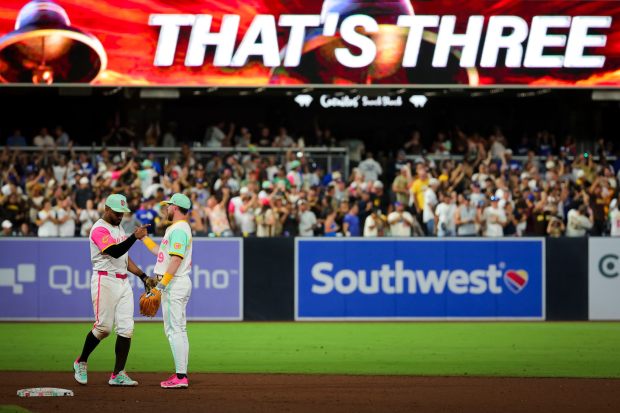 Xander Bogaerts #2 and Jake Cronenworth #9 of the San Diego Padres celebrate after defeating the Los Angeles Dodgers at Petco Park on Friday, Aug. 22, 2025 in San Diego, CA. (Meg McLaughlin / The San Diego Union-Tribune)