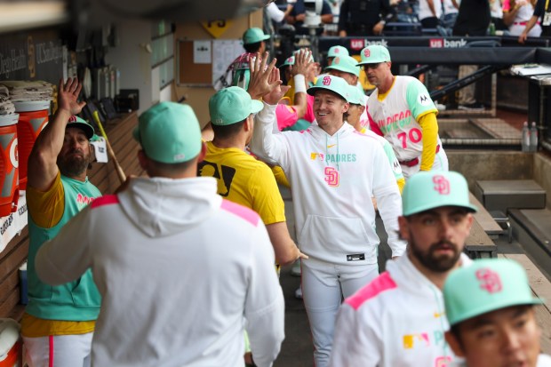 Bryce Johnson #29 of the San Diego Padres, center, high fives teammates before their game against the Los Angeles Dodgers at Petco Park on Friday, Aug. 22, 2025 in San Diego, CA. (Meg McLaughlin / The San Diego Union-Tribune)