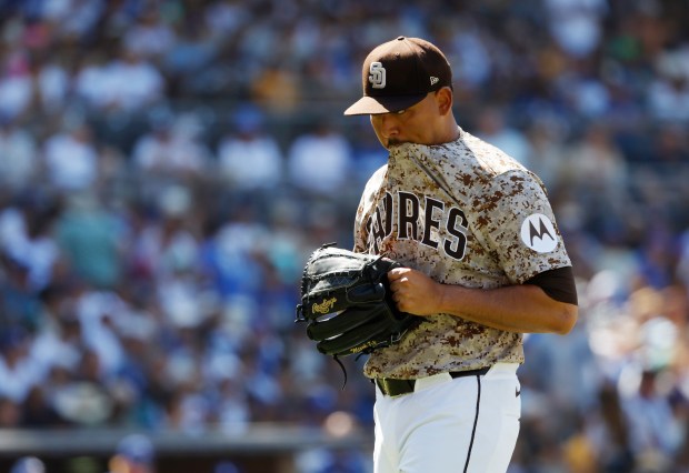 Jeremiah Estrada #56 of the San Diego Padres walks to the...