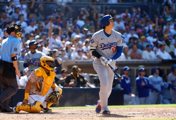 Shohei Ohtani #17 of the Los Angeles Dodgers watches a solo...