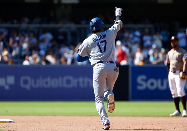 Shohei Ohtani #17 of the Los Angeles Dodgers rounds the bases...