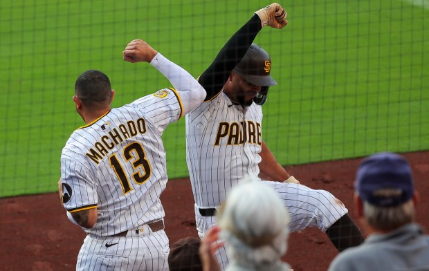 Manny Machado #13 and Xander Bogaerts #2 of the San Diego Padres celebrate after Bogaerts home run during the second inning against the Boston Red Sox at Petco Park on Saturday, Aug. 9, 2025 in San Diego, CA. (Meg McLaughlin / The San Diego Union-Tribune)