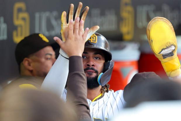 Fernando Tatis Jr. #23 of the San Diego Padres is congratulated in the dugout after scoring a run against the Boston Red Sox during the fifth inning at Petco Park on Saturday, Aug. 9, 2025 in San Diego, CA. (Meg McLaughlin / The San Diego Union-Tribune)