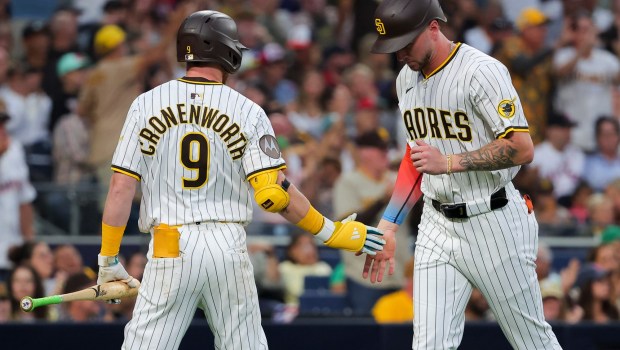 Jake Cronenworth #9 and Jackson Merrill #3 of the San Diego Padres celebrate after Merrill scored a run against the Boston Red Sox during the fifth inning at Petco Park on Saturday, Aug. 9, 2025 in San Diego, CA. (Meg McLaughlin / The San Diego Union-Tribune)