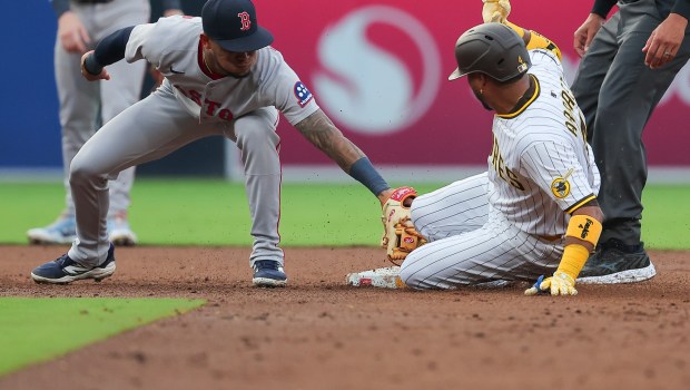 Ceddanne Rafaela #3 of the Boston Red Sox attempts to tag out Luis Arraez #4 of the San Diego Padres during the third inning at Petco Park on Saturday, Aug. 9, 2025 in San Diego, CA. (Meg McLaughlin / The San Diego Union-Tribune)