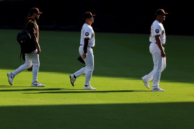 David Morgan #66, Yuki Matsui #1 and Wandy Peralta #58 of the San Diego Padres walk to the bullpen before their game against the Boston Red Sox at Petco Park on Saturday, Aug. 9, 2025 in San Diego, CA. (Meg McLaughlin / The San Diego Union-Tribune)