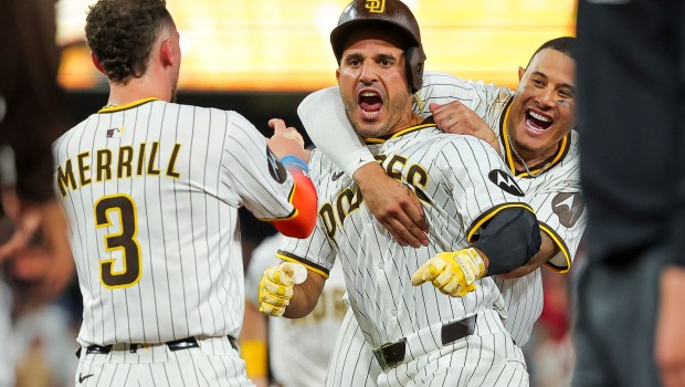 Manny Machado #13 and Ramon Laureano #5 of the San Diego Padres celebrate after Laureano hit a walk-off single against the Boston Red Sox during the tenth inning at Petco Park on Saturday, Aug. 9, 2025 in San Diego, CA. (Meg McLaughlin / The San Diego Union-Tribune)