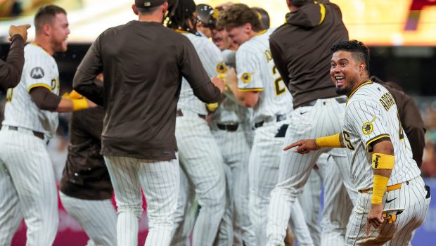 Luis Arraez #4 of the San Diego Padres and teammates celebrate after Ramon Laureano #5 hit a walk-off single against the Boston Red Sox during the tenth inning at Petco Park on Saturday, Aug. 9, 2025 in San Diego, CA. (Meg McLaughlin / The San Diego Union-Tribune)