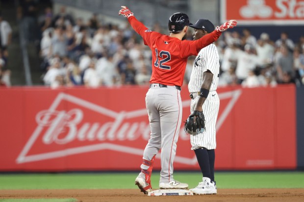 Boston Red Sox's Connor Wong, left, reacts next to New York Yankees second baseman Jazz Chisholm Jr. after hitting a double, leading Nathaniel Lowe to score, during the seventh inning of a game Friday. (AP Photo/Pamela Smith)
