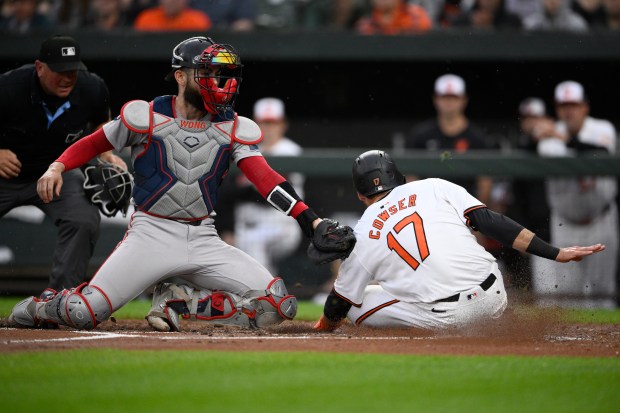 Baltimore Orioles runner Colton Cowser (17) scores against Boston Red Sox catcher Connor Wong during the second inning of Baltimore's 6-1 victory Wednesday in Baltimore. (AP Photo/Nick Wass)