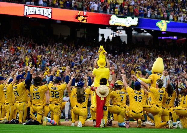The Savannah Bananas hoist a Savannah Banana baby dance during the game against The Firefighters at Coors Field in Denver, on Saturday, Aug. 09, 2025. (Photo by Andy Cross/The Denver Post)