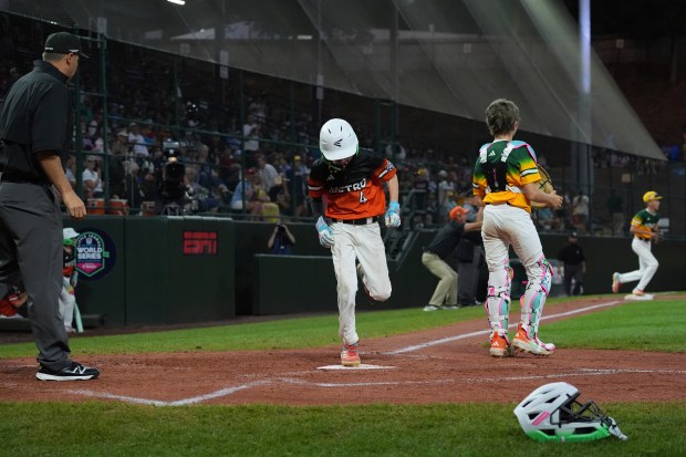 Fairfield, Conn.'s Ben Herbst (4) crosses home plate against Sioux Falls, S.D., during the fifth inning of a baseball game at the Little League World Series, Monday, Aug. 18, 2025, in South Williamsport, Pa. (AP Photo/Caleb Craig)
