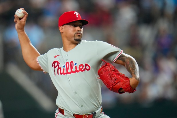 Philadelphia Phillies pitcher Jhoan Duran throws to the Texas Rangers during the ninth inning of a baseball game Saturday, Aug. 9, 2025, in Arlington, Texas. (AP Photo/Julio Cortez)