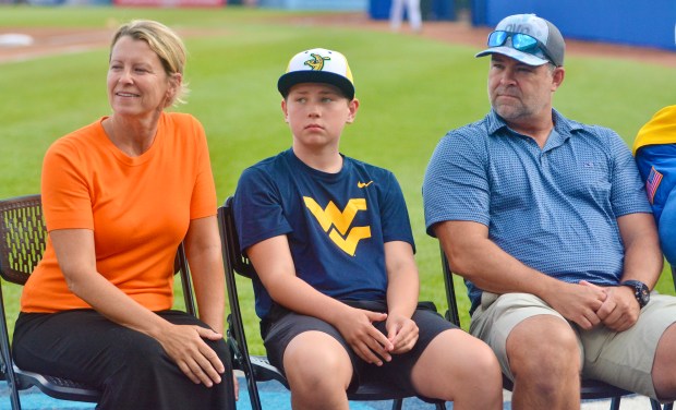 Baltimore Orioles groundskeeper Nicole Sherry with her son Tyson and...