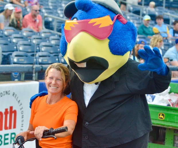 Baltimore Orioles head groundskeeper Nicole Sherry and Boomer pose for...