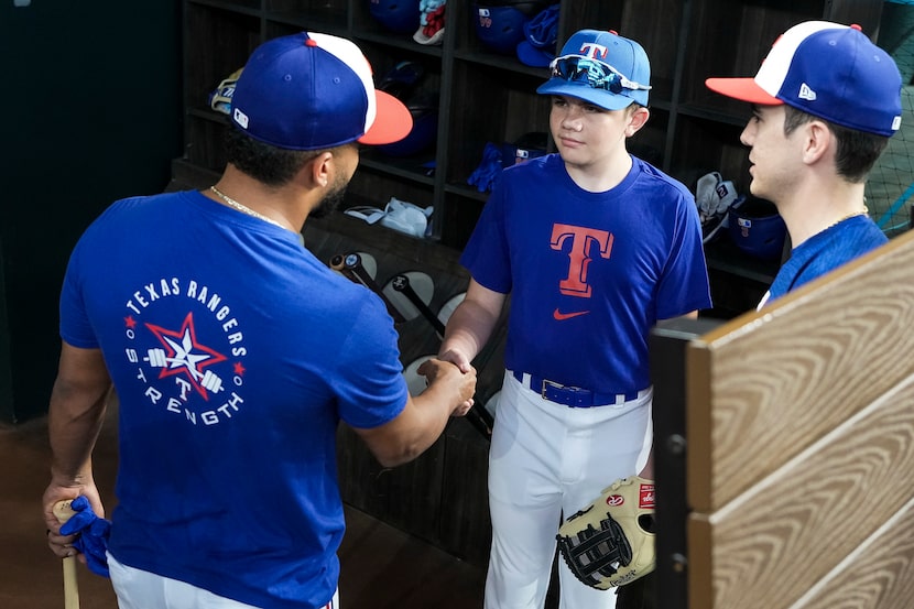 Make-a-Wish participant Vincent Caggiano is greeted by Texas Rangers infielder Ezequiel...