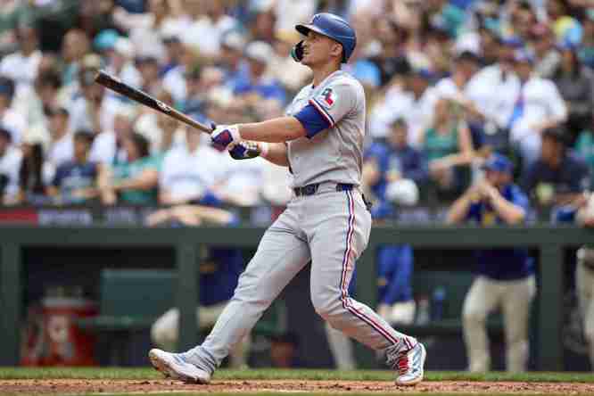 Aug 3, 2025; Seattle, Washington, USA; Texas Rangers shortstop Corey Seager (5) watches the flight of his two run home run off Seattle Mariners starting pitcher Logan Evans (73) during the third inning at T-Mobile Park. Mandatory Credit: John Froschauer-Imagn Images