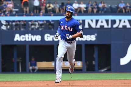 Texas Rangers' Marcus Semien runs the bases after hitting a two-run home run against the...
