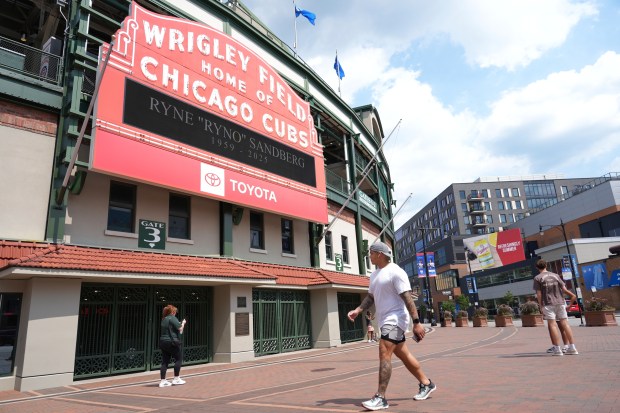 Fans visit as Wrigley Field marquee reads Ryne "Ryno" Sandberg 1959-2025 in honor of the death of Hall of Fame second baseman for the Chicago Cubs, Tuesday, July 29, 2025, in Chicago. (AP Photo/Nam Y. Huh)