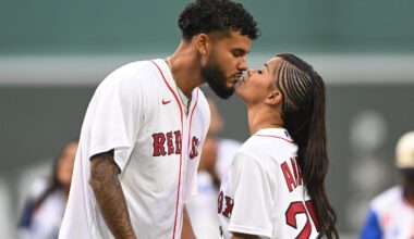 Amaya Espinal and Bryan Arenales of "Love Island USA" kissed after a ceremonial pitch before a game between the Kansas City Royals and the Red Sox on Aug. 4 at Fenway Park.