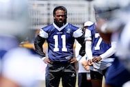 Dallas Cowboys defensive end Micah Parsons (11) watches training camp practice from the...