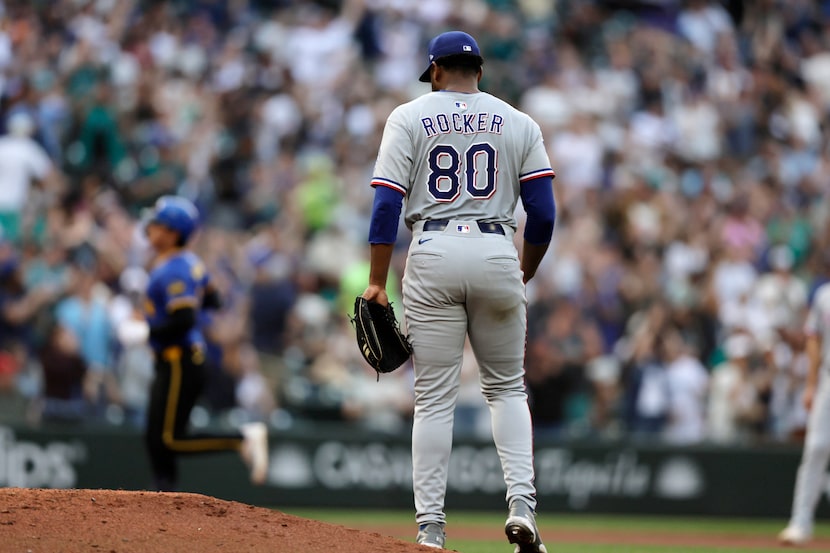 Texas Rangers starting pitcher Kumar Rocker (80) watches as Seattle Mariners' Cole Young,...