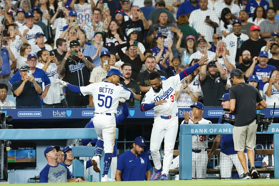 Dodgers shortstop Mookie Betts, left, celebrates with right fielder Teoscar Hernández after hitting a home run.