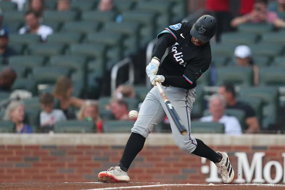 Aug 8, 2025; Cumberland, Georgia, USA; Miami Marlins shortstop Xavier Edwards (9) gets a base hit against the Atlanta Braves during the first inning at Truist Park. Mandatory Credit: Mady Mertens-Imagn Images