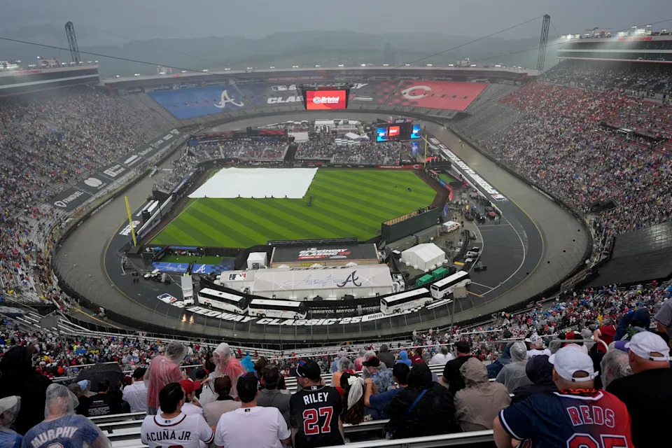 The field is covered up during a rain delay at the MLB Speedway Classic baseball game between the Atlanta Braves and the Cincinnati Reds at Bristol Motor Speedway in Bristol, Tenn., Saturday, Aug. 2, 2025. (AP Photo/George Walker IV)