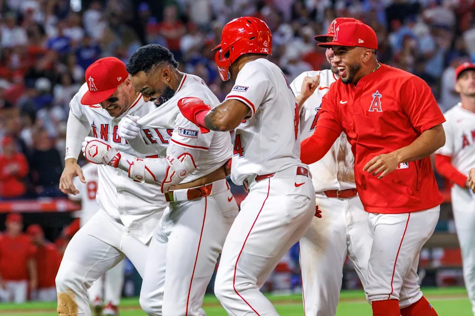 Teammates swarm Jo Adell after his walk-off hit
