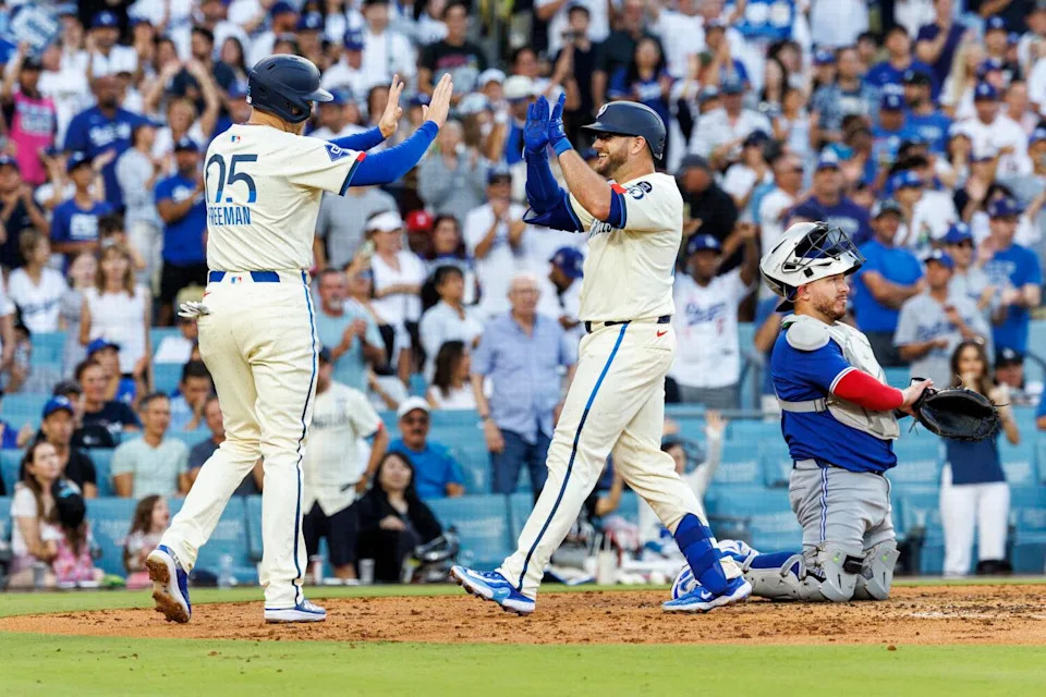 Max Muncy, right, celebrates with Freddie Freeman after hitting a two-run home run in the fourth inning Saturday.