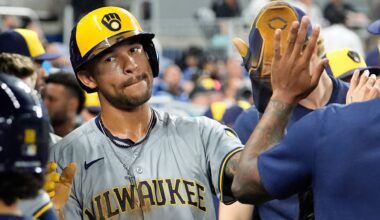 Milwaukee Brewers' Blake Perkins (16) is high-fived in the dugout after scoring on a single hit by William Contreras during the fourth inning of a baseball game against the Miami Marlins, Tuesday, May 21, 2024, in Miami.