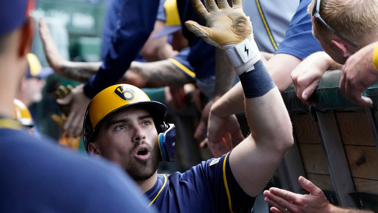 Milwaukee Brewers' Caleb Durbin is greeted in the dugout after hitting a two-run home run against the Chicago Cubs during the second inning of a baseball game Thursday, June 19, 2025, in Chicago.